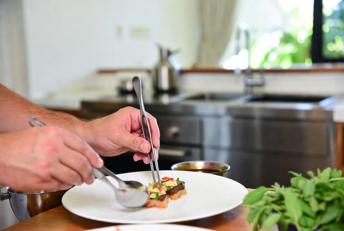 Private chef plating gourmet courses in a Bali villa kitchen