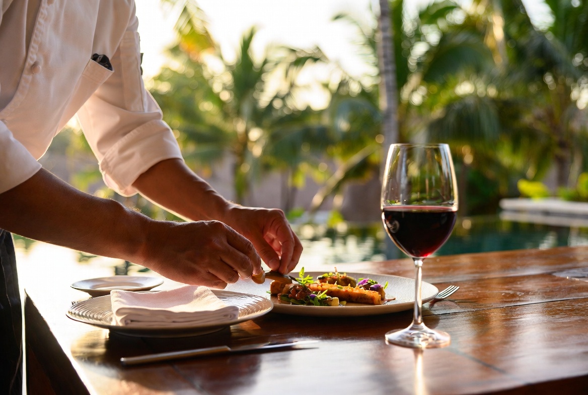 Private chef plating fine dining courses on a Seminyak villa terrace
