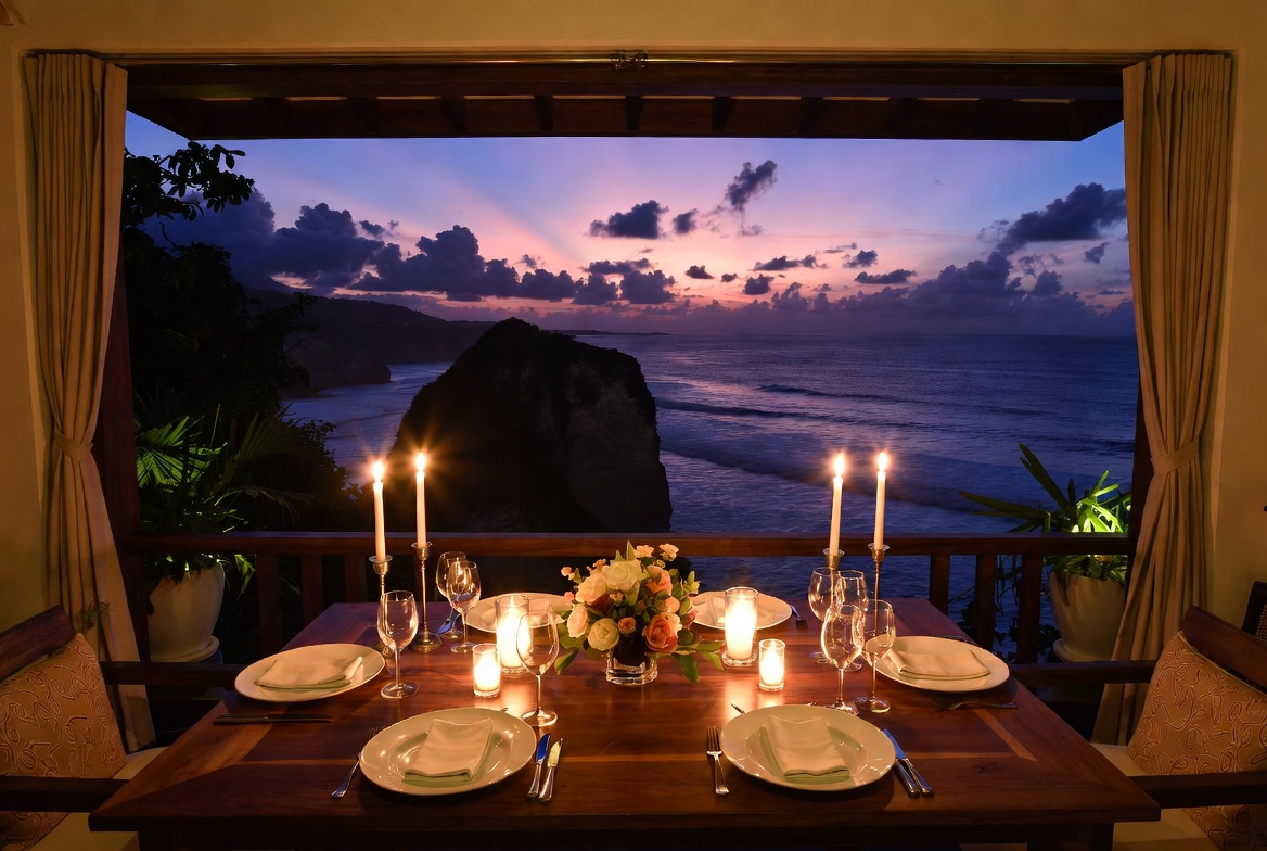 Candlelit honeymoon dinner table overlooking the ocean in Bali