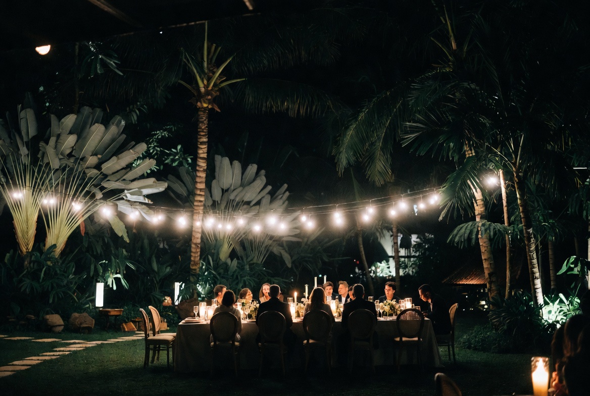 Evening villa wedding dinner under string lights with private chef catering in Bali